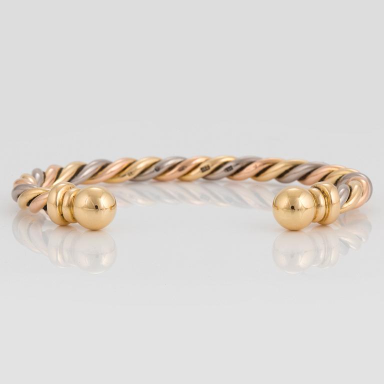 A Gaudy bangle in 18K tri color gold.