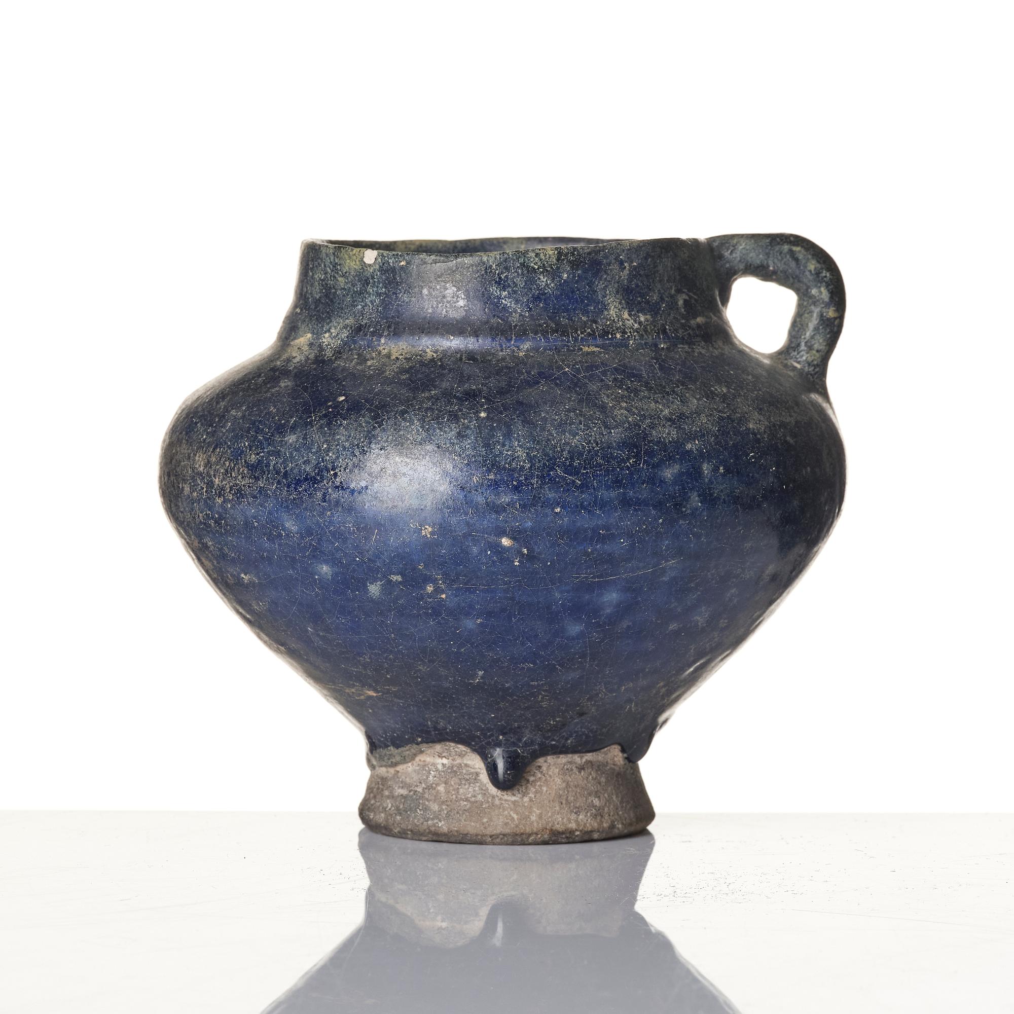A blue-glazed Nishapur pottery Jug, Persia, 13th century.