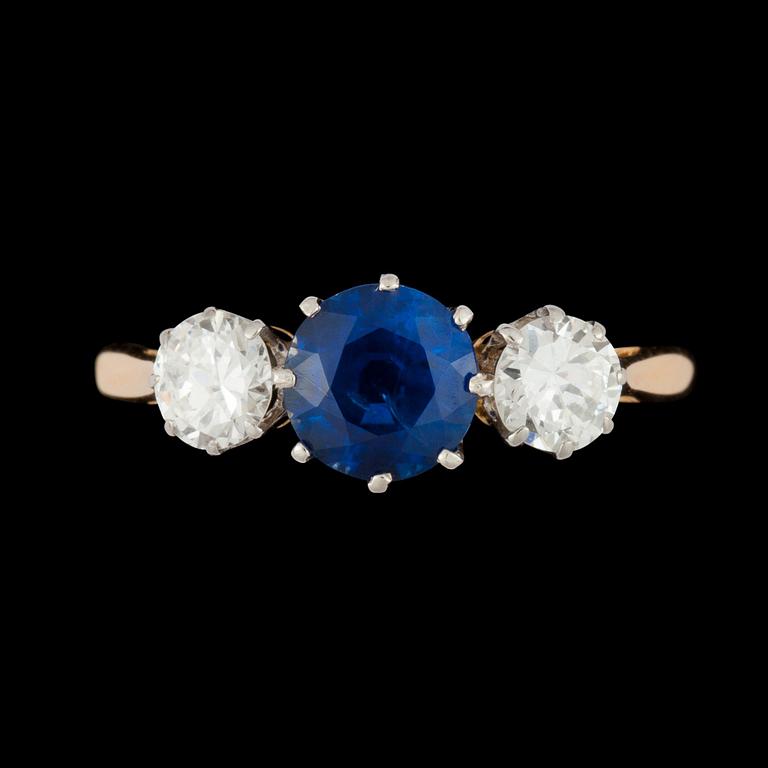 A facett cut sapphire ring set with brilliant cut diamonds.