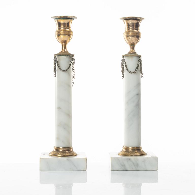 A pair of gilt-brass and marble late Gustavians candlesticks, late 18th century.