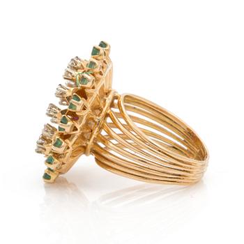A brilliant cut diamond, emerald and ruby ring.