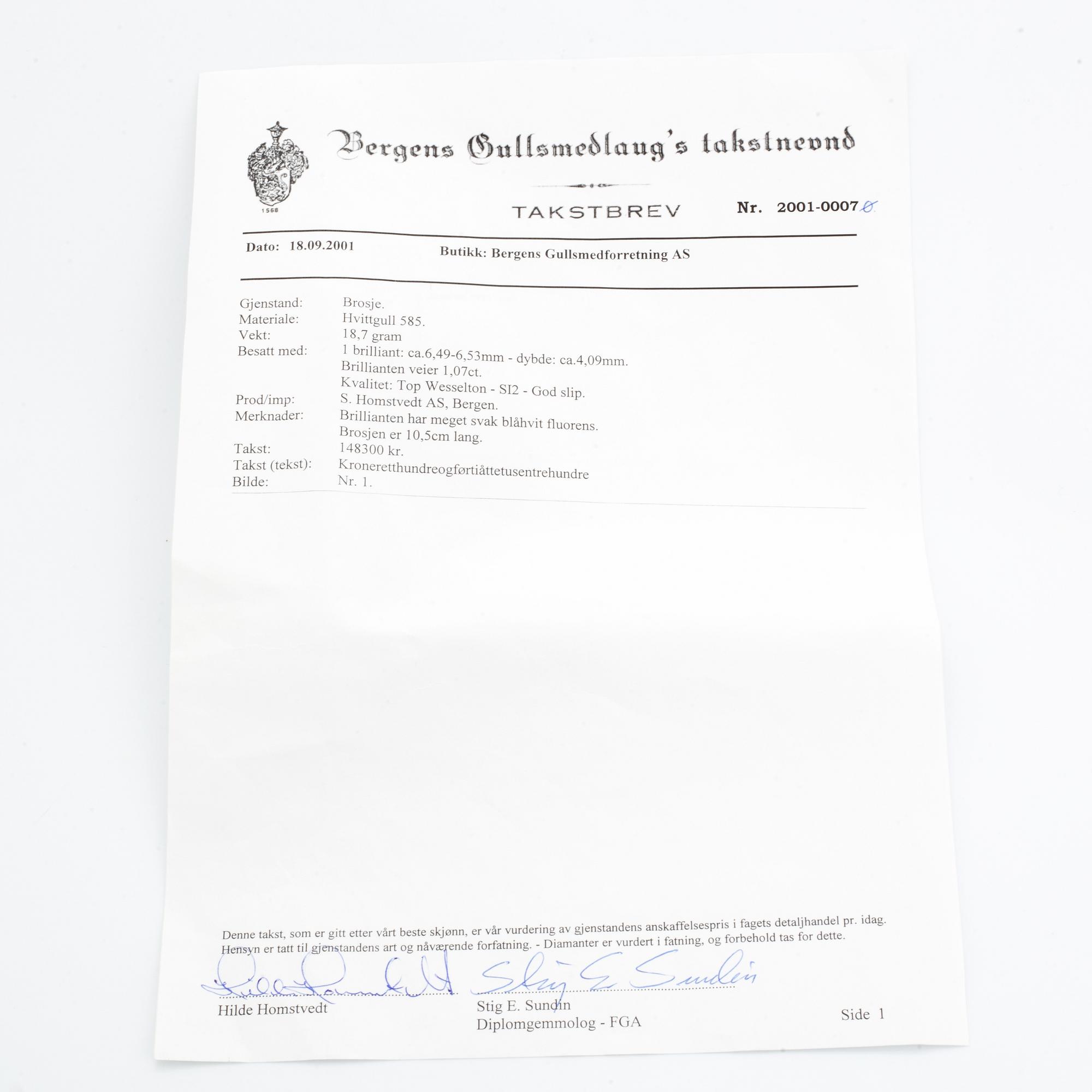 A 14K gold brooch set with a round brilliant-cut diamond.