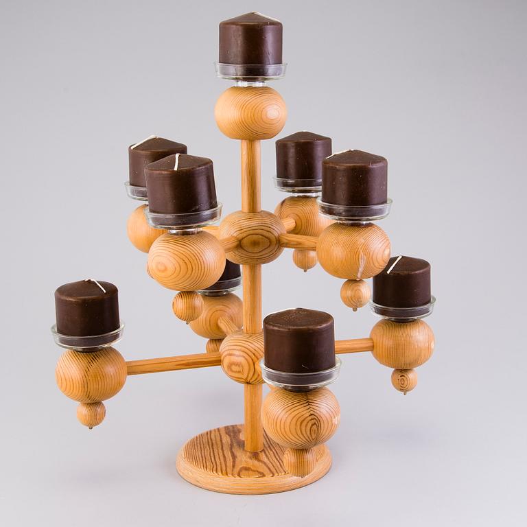 A Finnish wood and glass candelabra, marked Aarikka made in Finland.