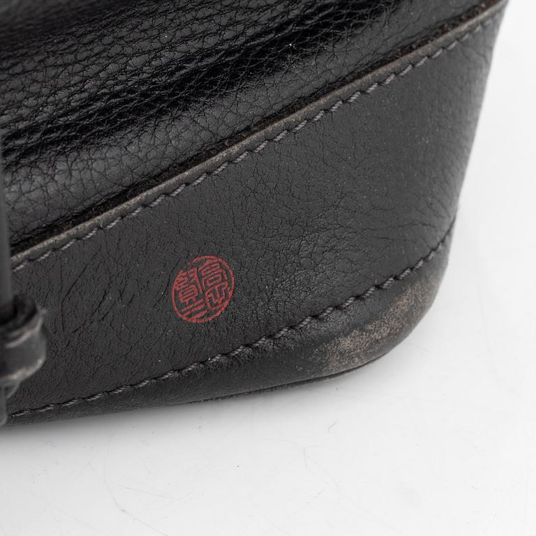 Kenzo, a black leather bucket bag.