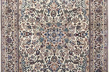 A Nain carpet, part silk, 9 laa, c. 318 x 209 cm.