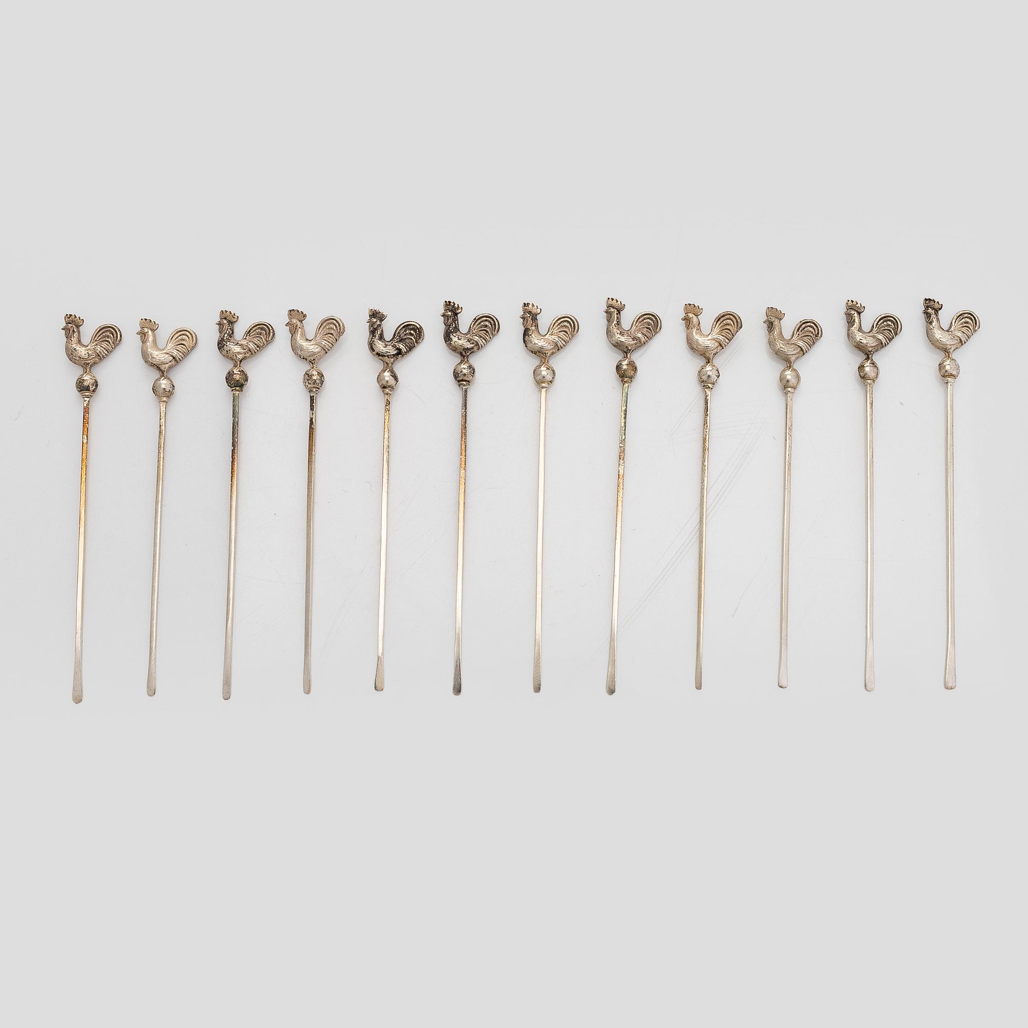 A set of 12 silver glass coasters, Auran Kultaseppä Oy Turku 1935 and 1983, and cocktail sticks, 12 pcs silver.