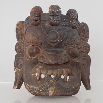Four Tibetan/South East Asian wooden decorations, 20th century.
