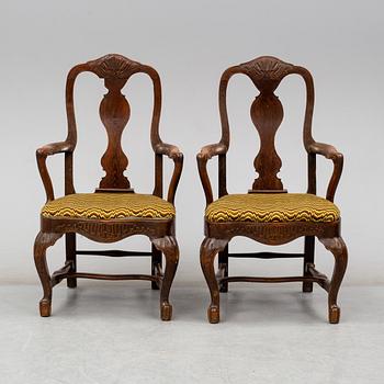 A pair of oak baroque style armrest chairs, 1920s.