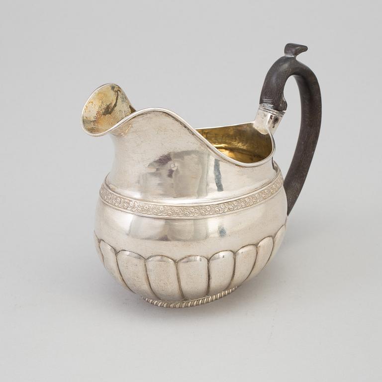 A Russian Empire parcel-gilt cream jug, maker's mark Elias Modig (1795-1834), St Petersburg, 1824.