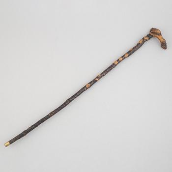 A carved wooden cane, 19th century.