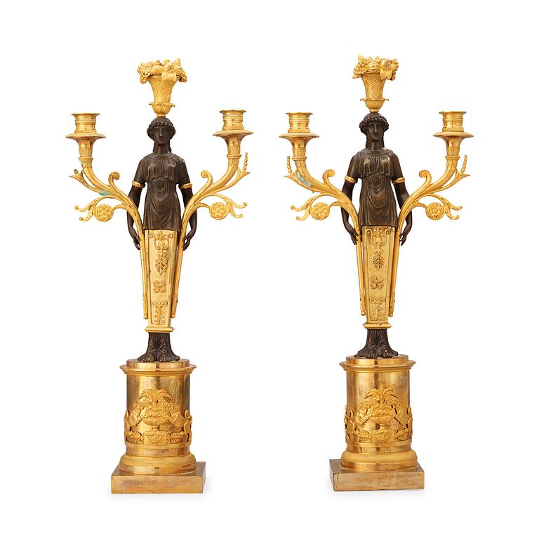 A pair of Empire early 19th century three-light candelabra.