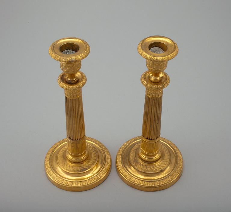 A PAIR OF EMPIRE CANDLESTICKS.