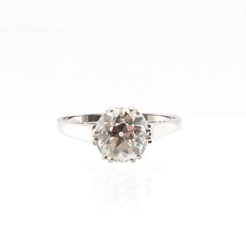 An 18K white gold solitaire ring set with a round old-cut diamond.