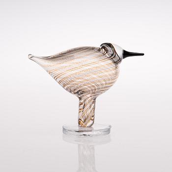 A footed glass bird signed O. Toikka Nuutajärvi.