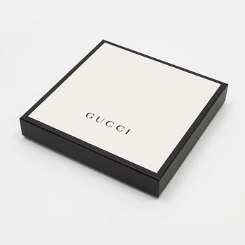 Gucci, a wool and silk mix "GG" jaquard shawl.