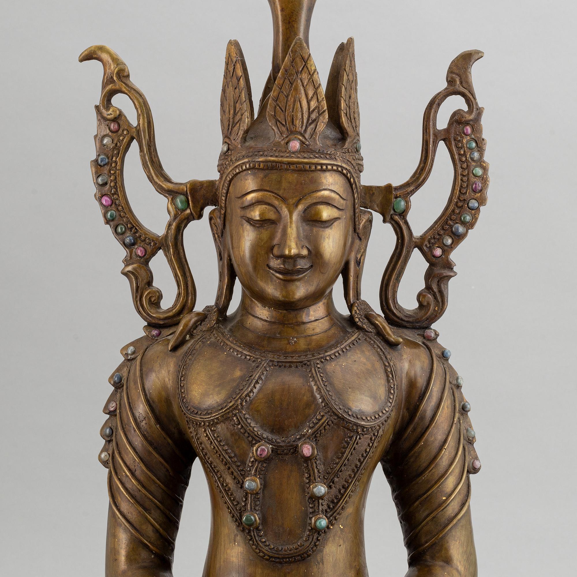 A seated buddha, yellow metal, possibly Nepal, 20th century.