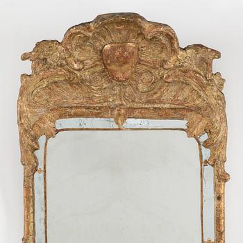A second half of the 18th century rococo mirror sconce.