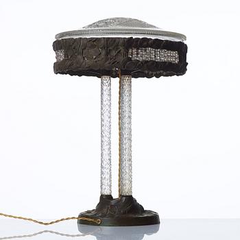 A Swedish Art Nouveau patinated brass and cut glass table lamp, Böhlmark's, Stockholm 1909-20.