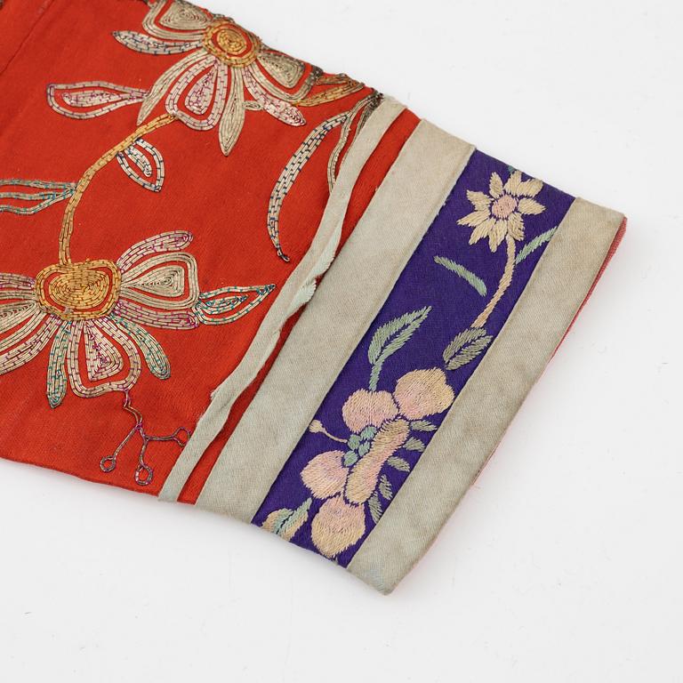 A Chinese embroidered silk jacket for children, late Qing dynasty, around 1900.