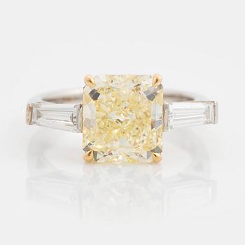 397. A Gübelin platinum and 18K gold ring set with a radiant-cut diamond 3.21 cts Fancy Intense Yellow.