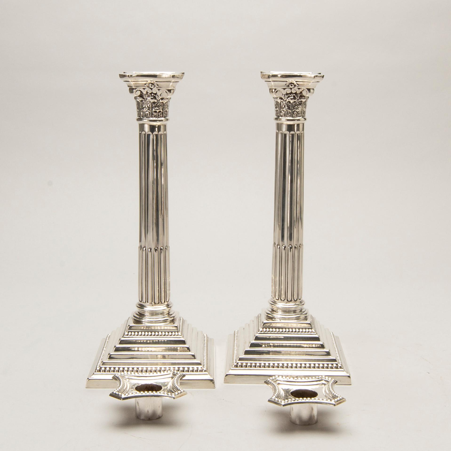 A pair of classical column sterling silver candlesticks Birmingham, 1934, by 'B.G. & Co'.