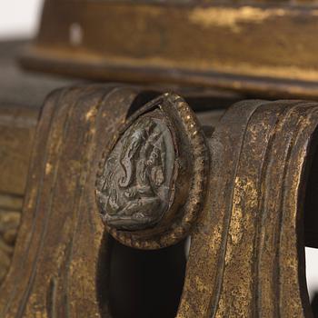 A large Nepalese gilt bronze buddha on a throne with mandorla, 18/19th Century.