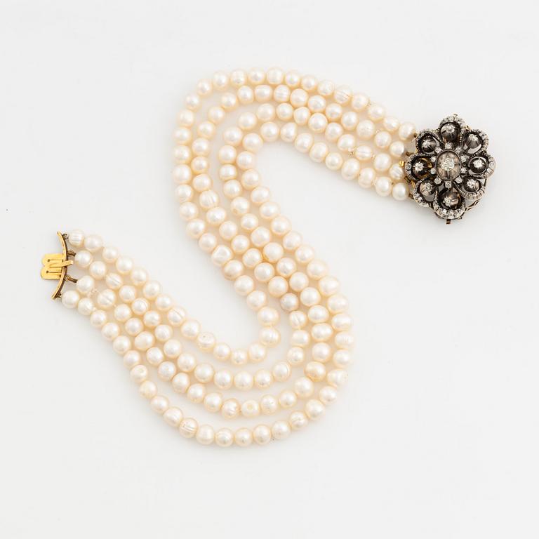Collier/brooch, four-stranded with cultured pearls, clasp with old-cut diamonds.