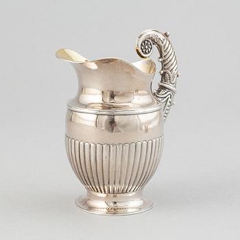 A silver creamer by Johan Petter Ahlforss, Strängnäs, 1833 and a silver sugar box, Kristianstad, 1928.