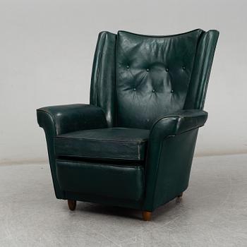 A Collins & Hayes armchair, mid 20th century. Signed with label.