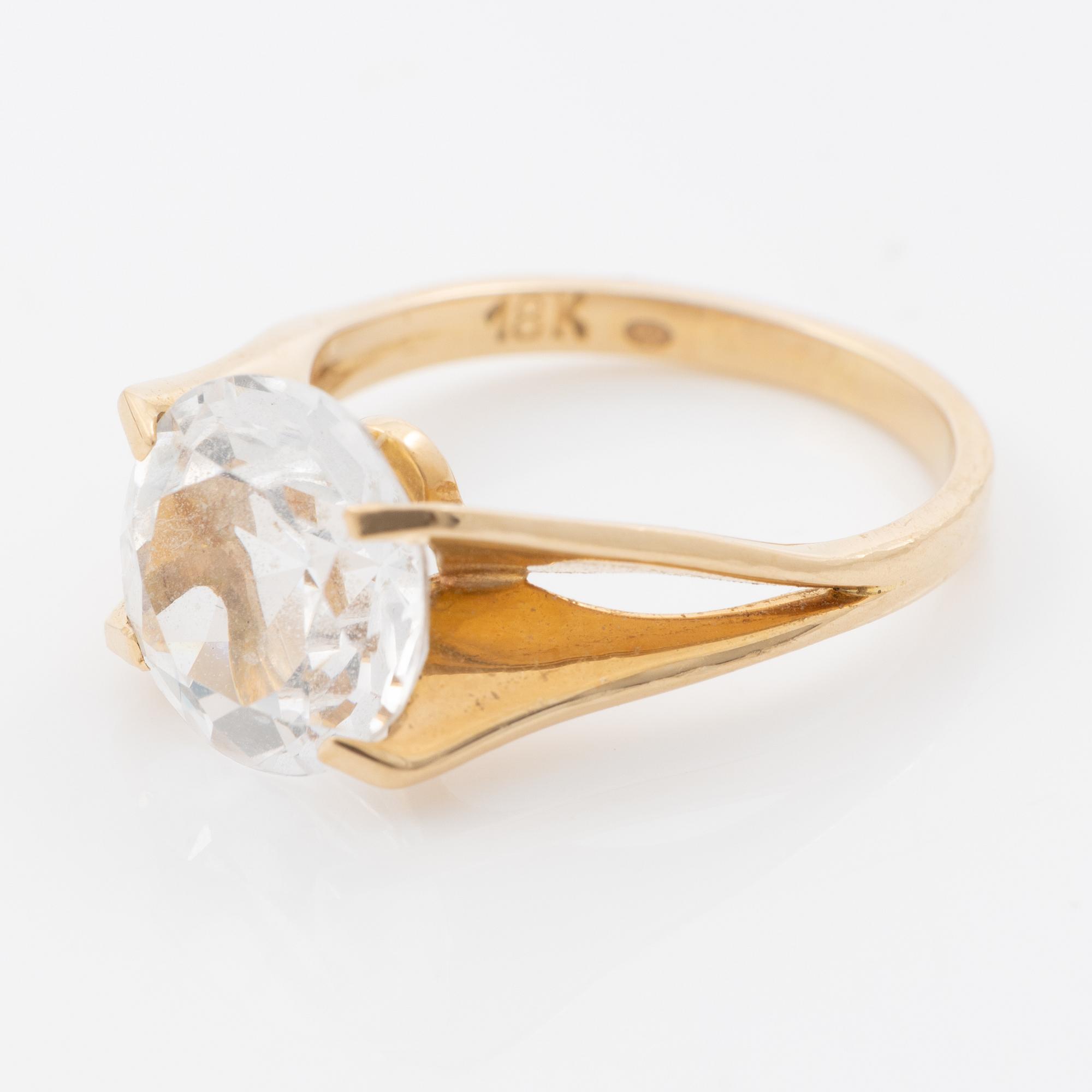 Ring, 18K gold with a synthetic white stone.