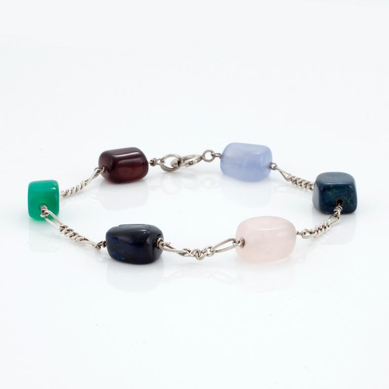 A silver necklace and bracelet set with polished, multi-coloured stones.