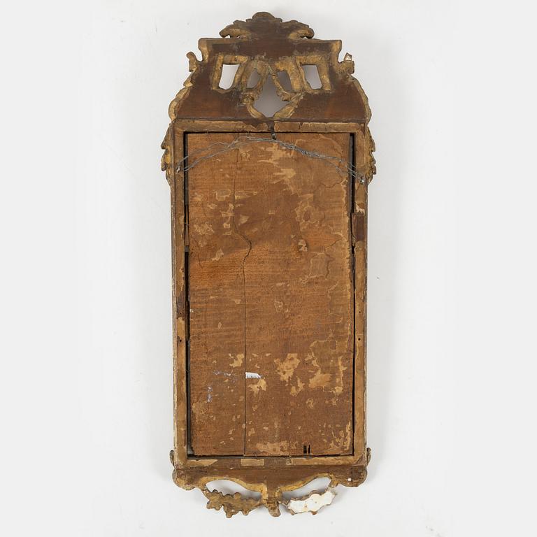 A Gustavian carved giltwood mirror, Stockholm, late 18th century.