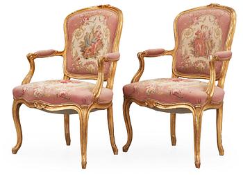 670. A pair of Rococo 18th century armchairs.