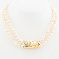 Necklace, two-stranded of cultured pearls with a clasp of 18K gold set with brilliant-cut diamonds, Damini Asolo Italy.