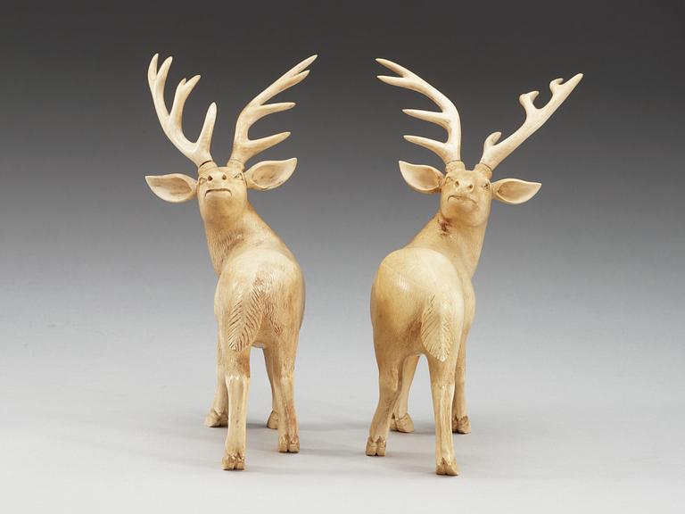 A pair of ivory figures of deers, Qing dynasty, presumably Qianlong (1736-95).