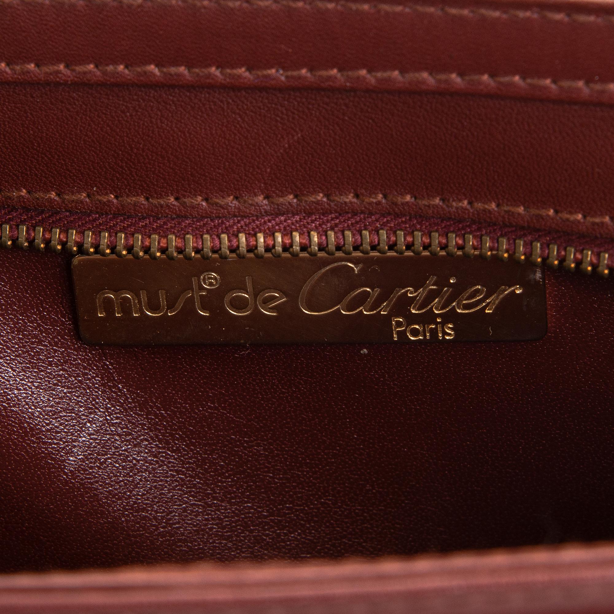 Must de Cartier bag clutch with accessories.