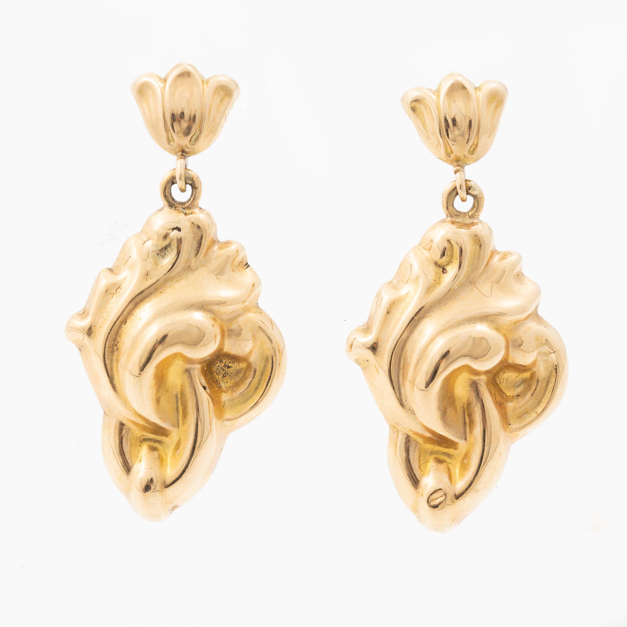 A pair of 18K gold earrings.