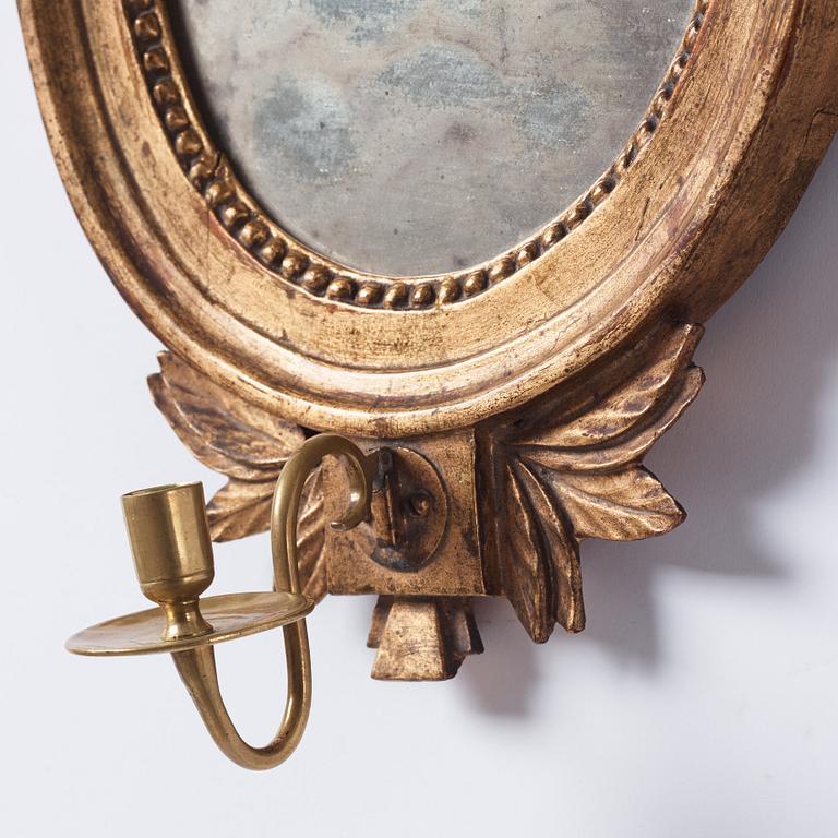 A pair of Gustavian late 18th century one-light girandole mirrors.