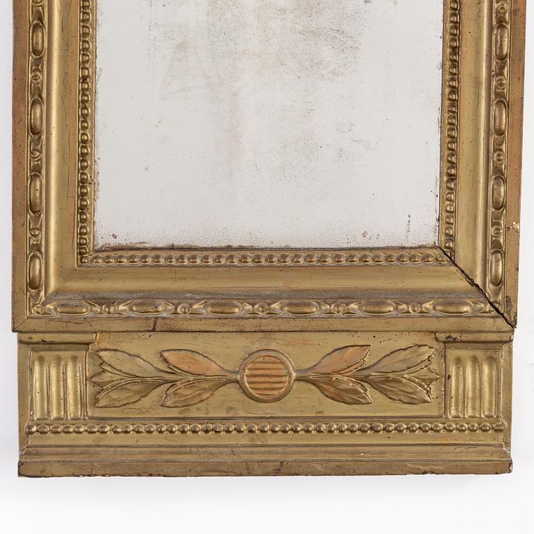 A lage Gustavian mirror.