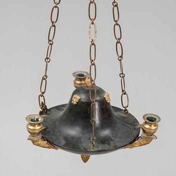 A Swedish Empire style 20th century three-light patinated brass hanging-lamp.