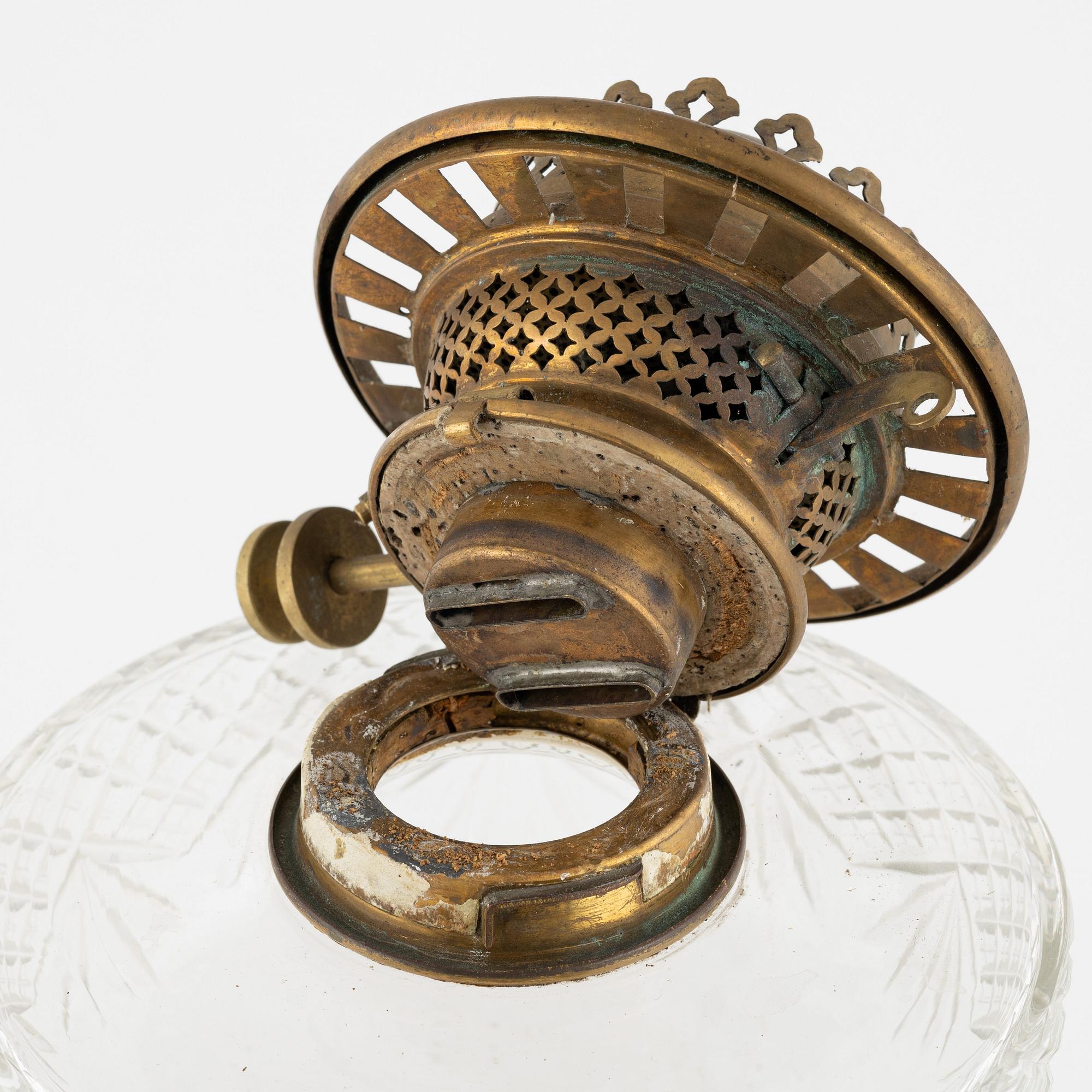 A brass and glass column shaped paraffin lamp, end of the 19th Century.
