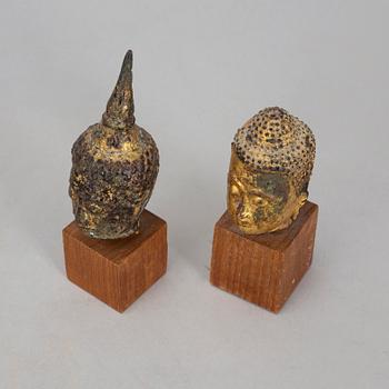 A group of two heads in wood and bronze, Thailand, Bangkok, circa 1900.