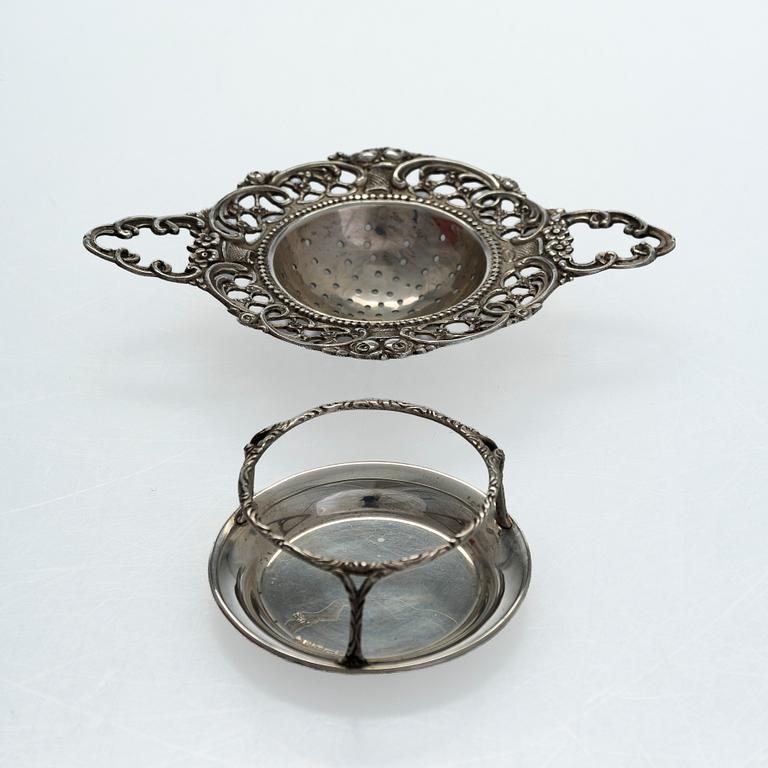A pair of Russian silver salt cellars, a sprinkle spoon, a sauce ladle, and a tea strainer, Finnish marks.