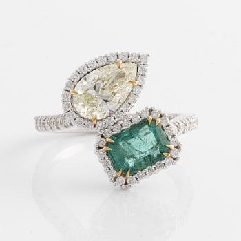 Ring with emerald-cut emerald and pear-shaped diamond, accompanying GIA diamond report.