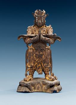 A gilt bronze figure of a warrior, Qing dynasty, 17th Century.