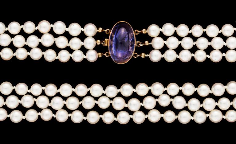 A three strand cultured pearl necklace.