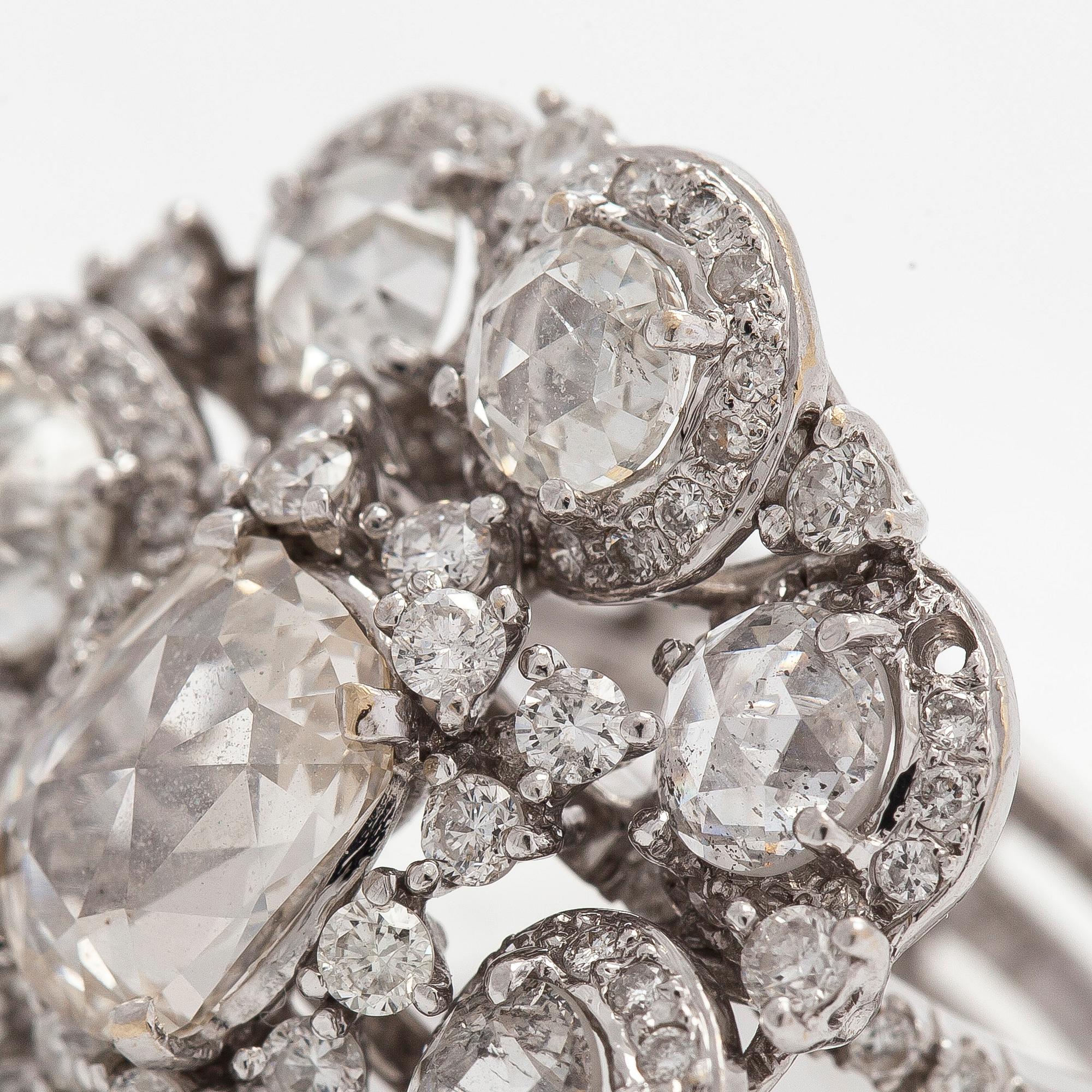 An 18K white gold ring set with rose-cut and brilliant-cut diamonds.