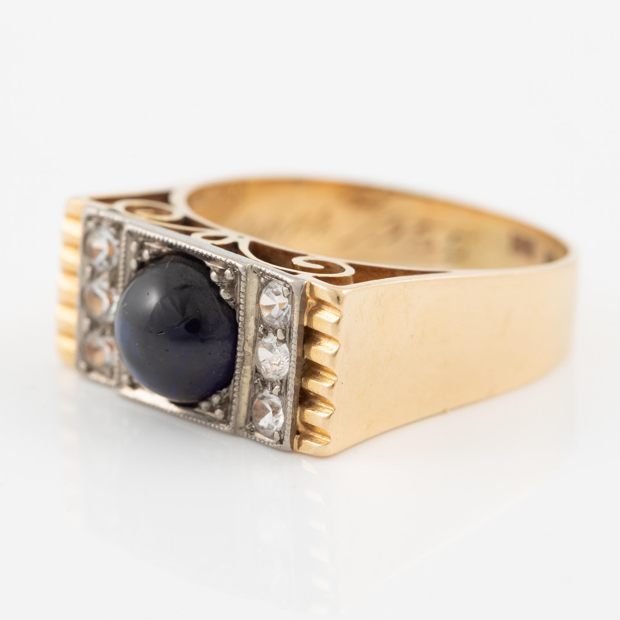 Ring 18K gold with cabochon-cut sapphire and white stones.