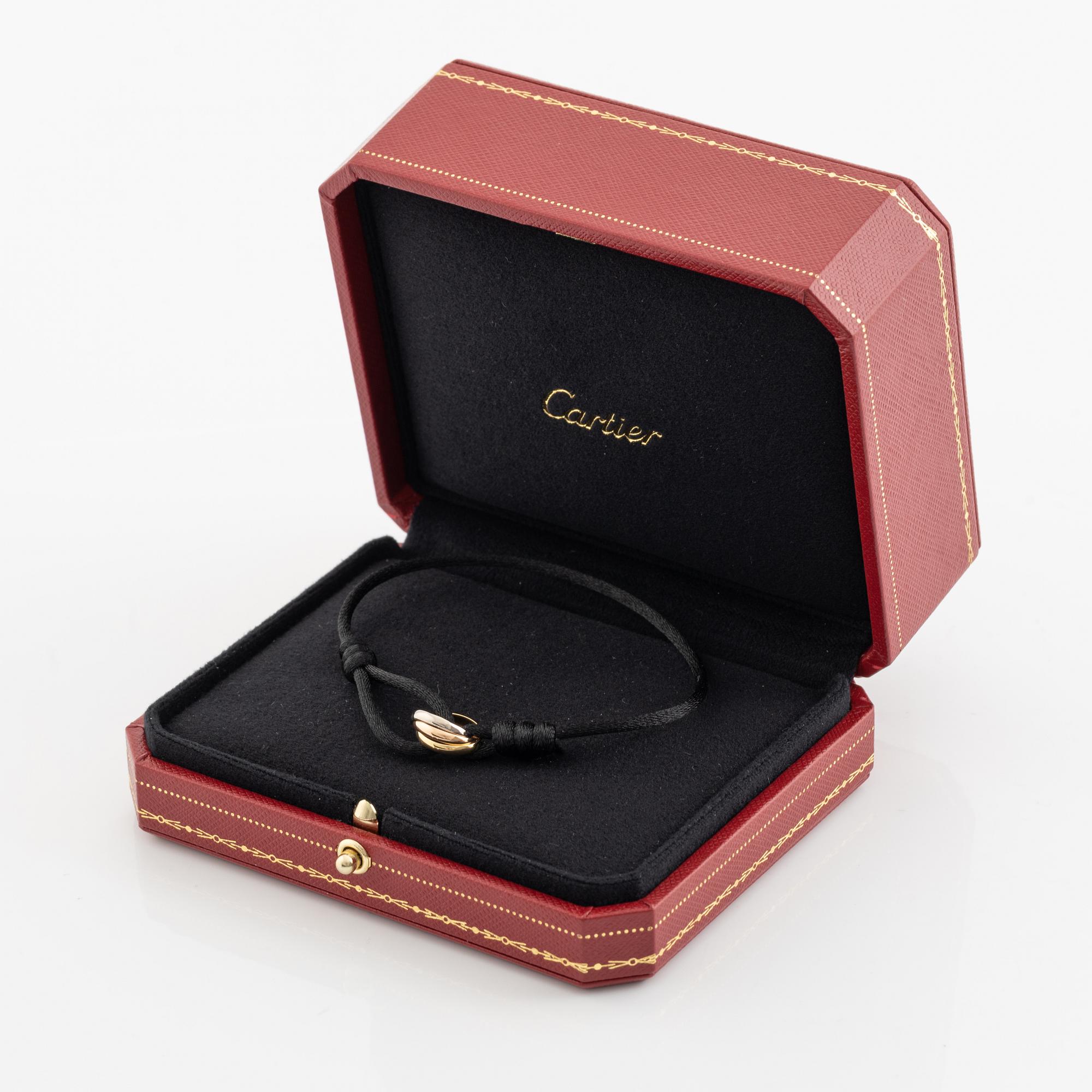 A Cartier "Trinity" bracelet, 18K three colour gold and textile.