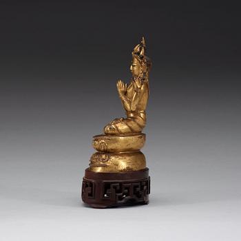 A gilt copper alloy figure of Sukhavati Avalokiteshvara seated on a high lotus base, Tibet, 15th/16th Century.